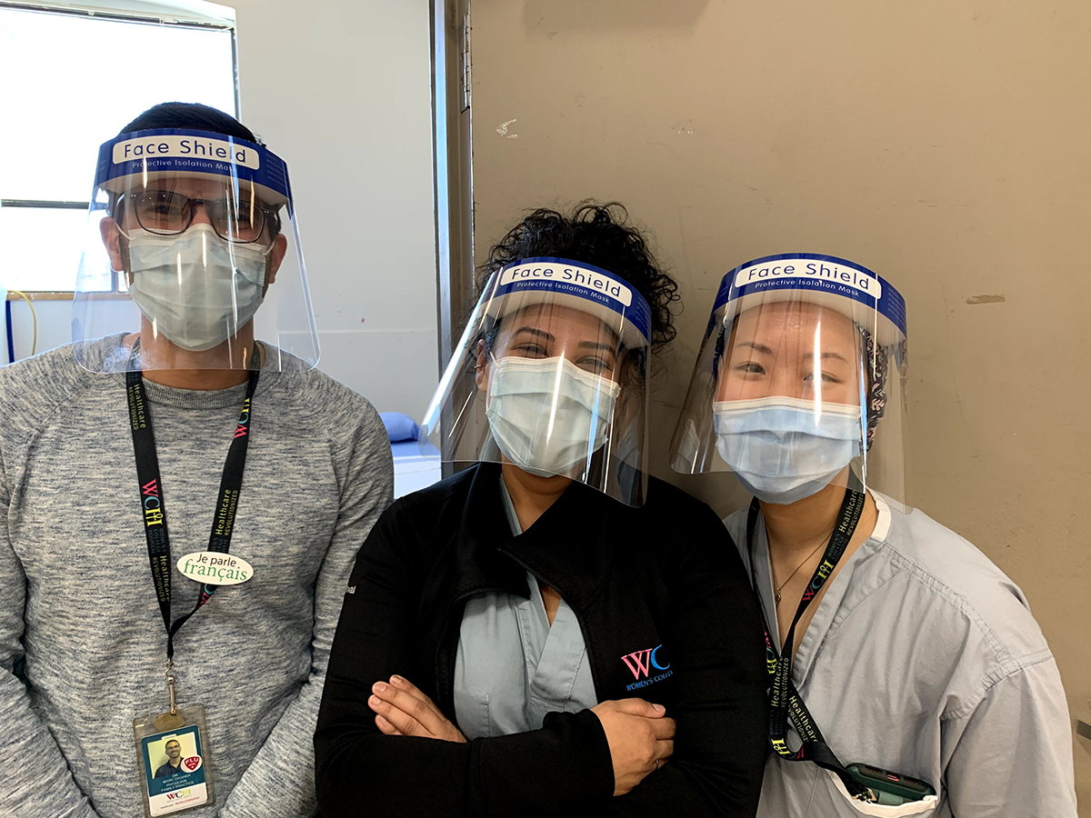 A team of healthcare workers in masks and face shields
